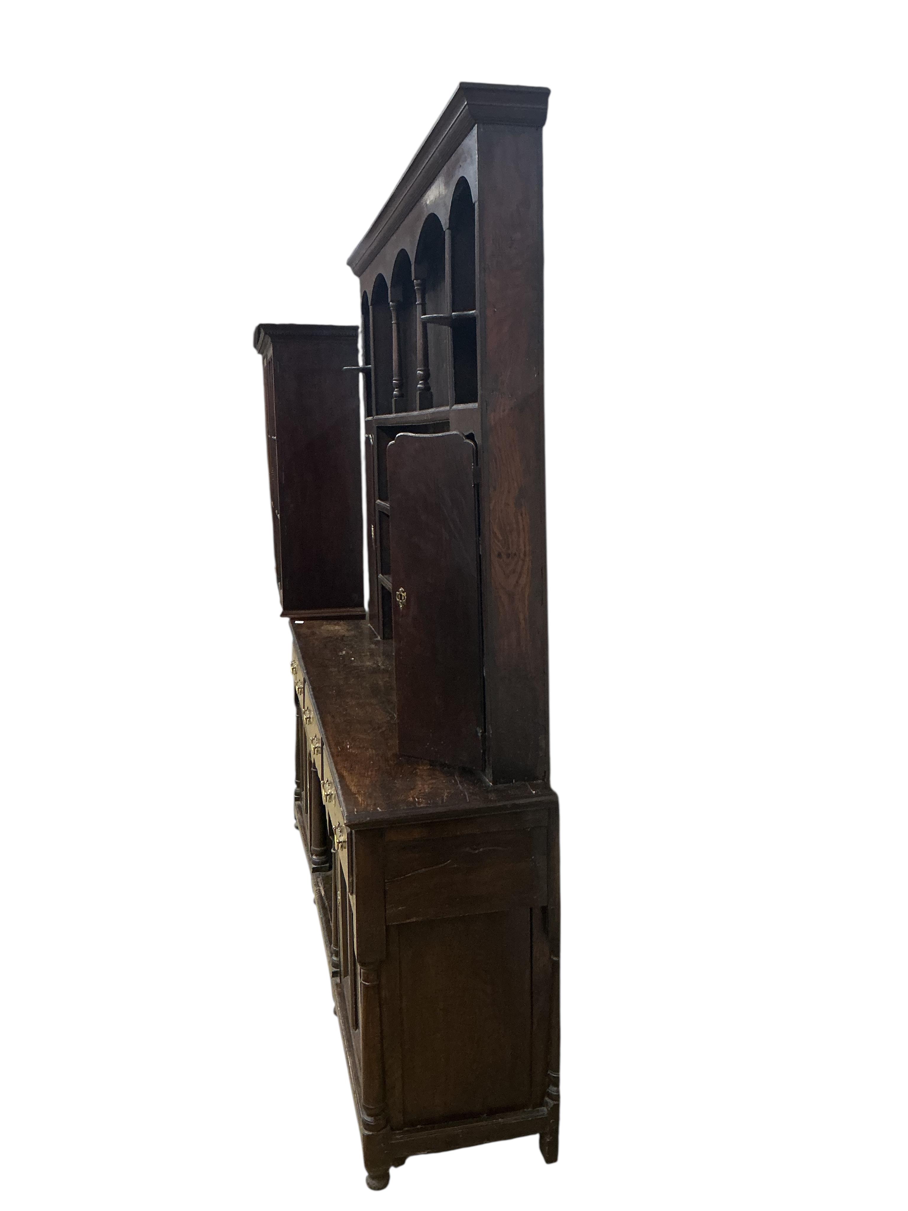 An 18th century and later oak 'dog kennel' dresser with boarded rack, width 216cm, depth 45cm, height 248cm